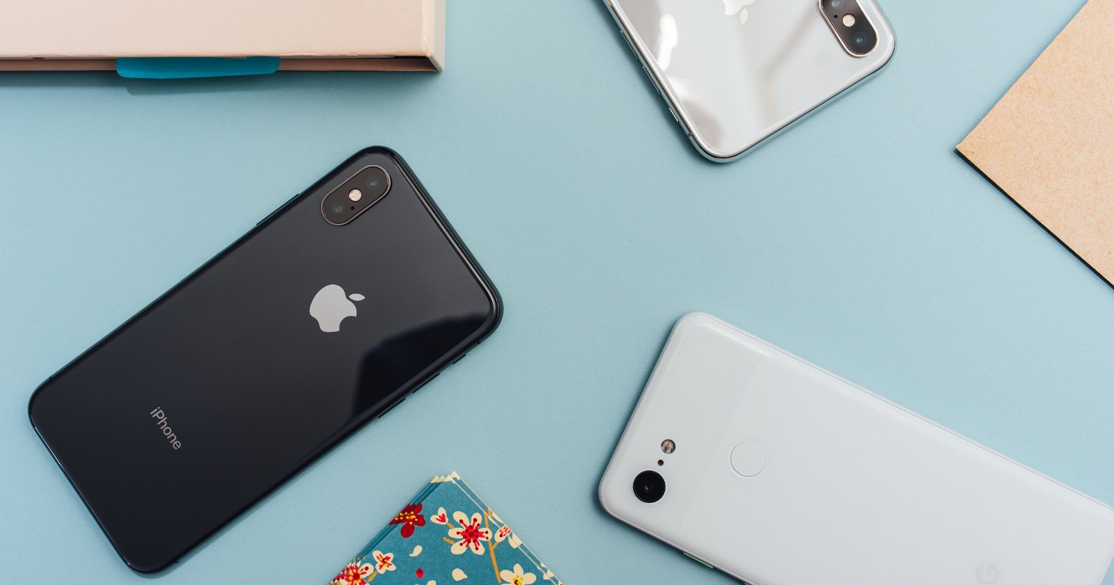 Varios iPhone y un smartphone Android sobre una mesa.